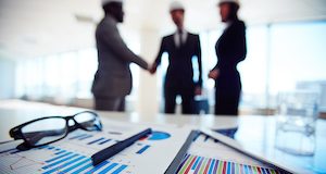Business documents on background of three business partners